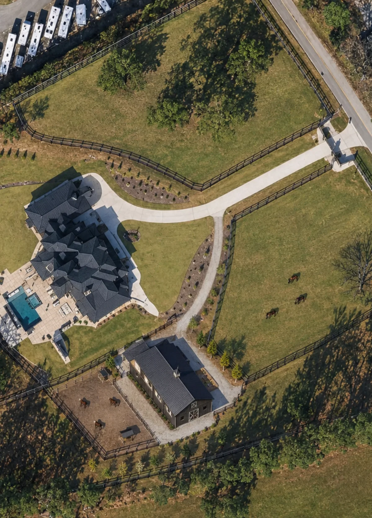 Overhead view of the horse barn, paddock, and pasture fencing at Horse Boarding Georgia in Buford GA